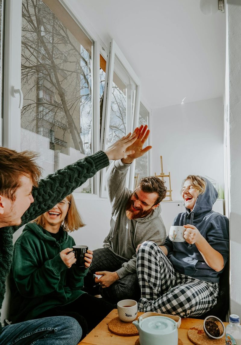 woman in black and white checkered long sleeve shirt sitting beside man in green crew neck